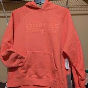 Fear of God Essentials Hoodie in Coral